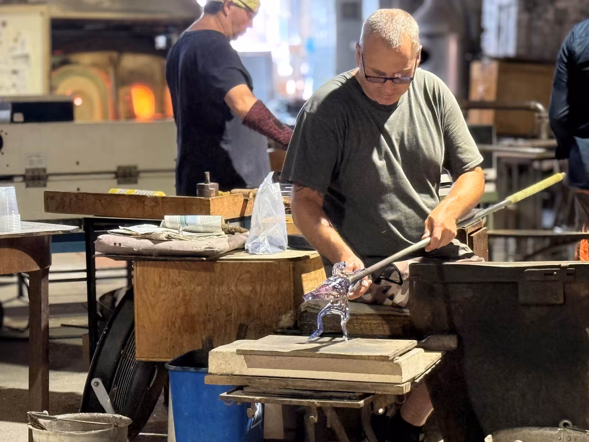 Glass artisan crafting intricate piece in Murano, showcasing traditional glassblowing on Venice Islands guided cruise.