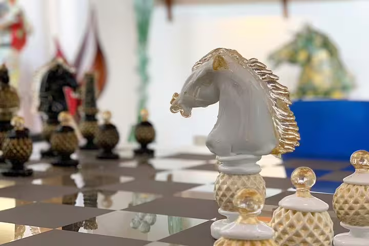 Ornate chess piece in Murano glass shop on Grand Canal tour, illustrating exquisite Venetian artistry.