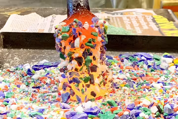 Colorful glass pieces being crafted in Murano, showcasing the vibrant art of glassmaking on the private tour.