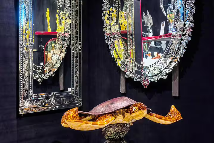 Exquisite Murano glass mirrors and turtle sculpture, showcasing Venetian artistry on a Private LimoBoat tour.