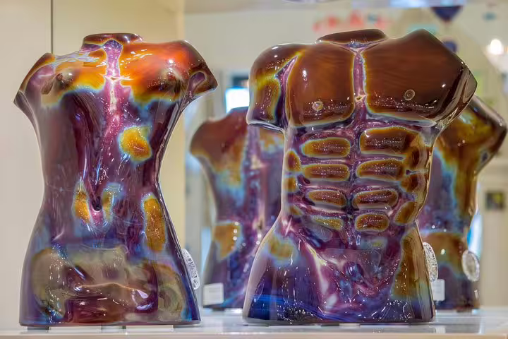 Colorful Murano glass sculptures on display, artisan stop on a private Grand Canal boat tour to Burano