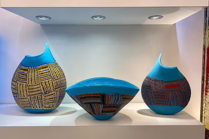 Exquisite blue and patterned Murano glass vases displayed on a Grand Canal tour from San Marco Square.