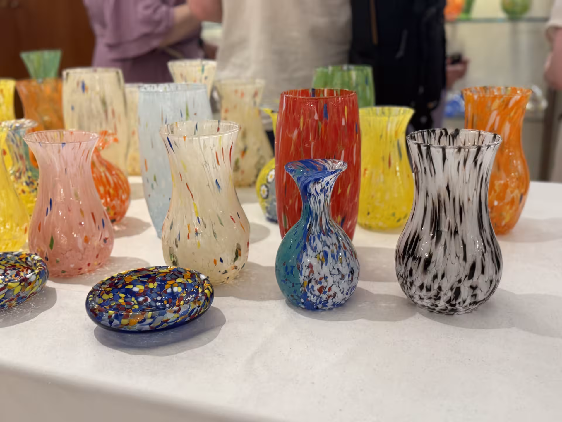 Colorful Murano glass vases and dishes on display during the Venice tour showcasing traditional craftsmanship.