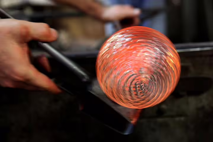 Murano glassblowing close-up with glowing molten glass on a private boat tour from Venice