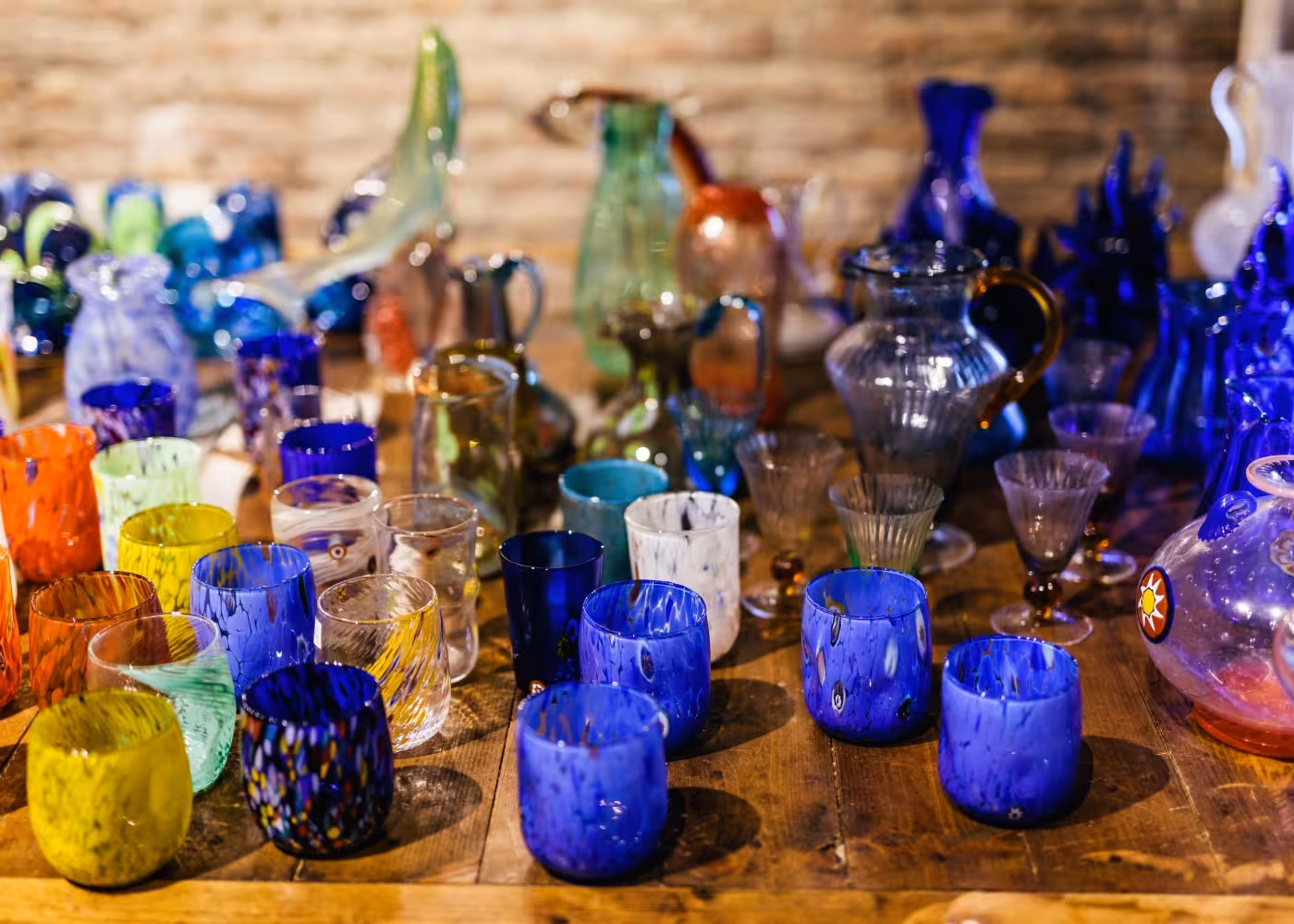 Colorful handcrafted Murano glassware on display during exclusive tour of Murano Island's glass-making workshops.