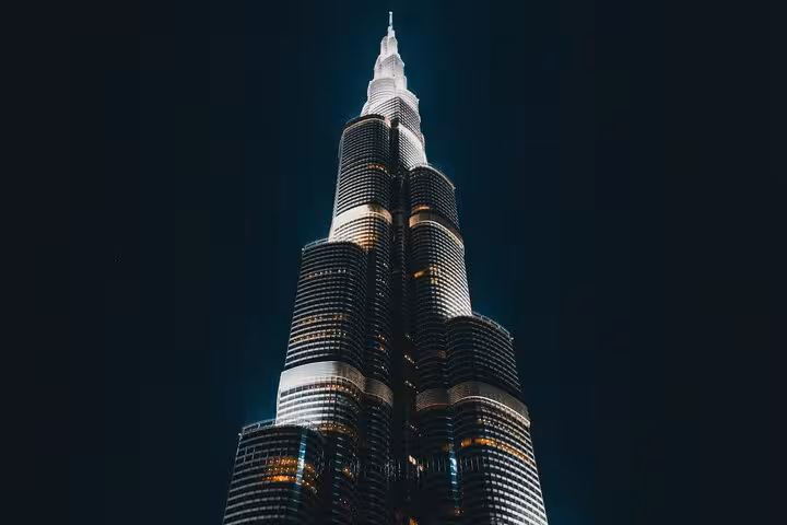 Night view of Burj Khalifa in Dubai, a highlight of the Muscat to Dubai private transfer city sightseeing experience