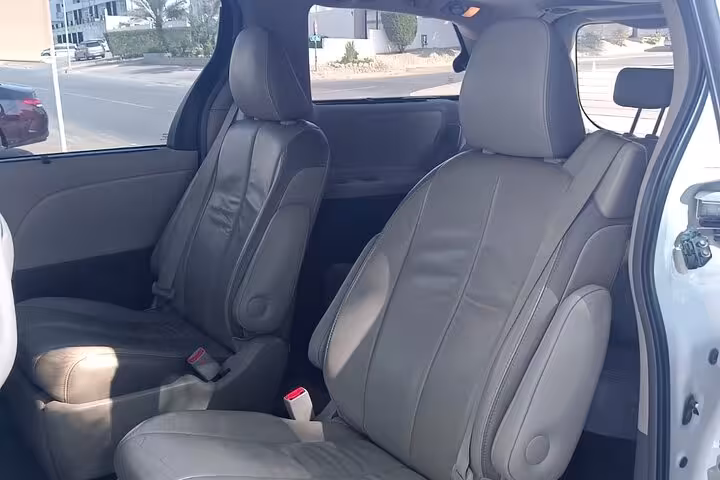Spacious leather seats inside private transfer minivan used for Muscat to Dubai journey, offering comfort and legroom