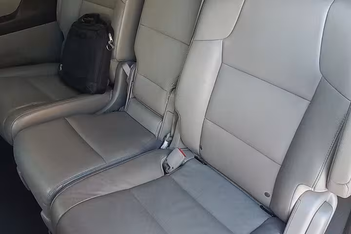 Clean leather rear seats of modern minivan offering comfortable group travel on a private Muscat to Nizwa transfer