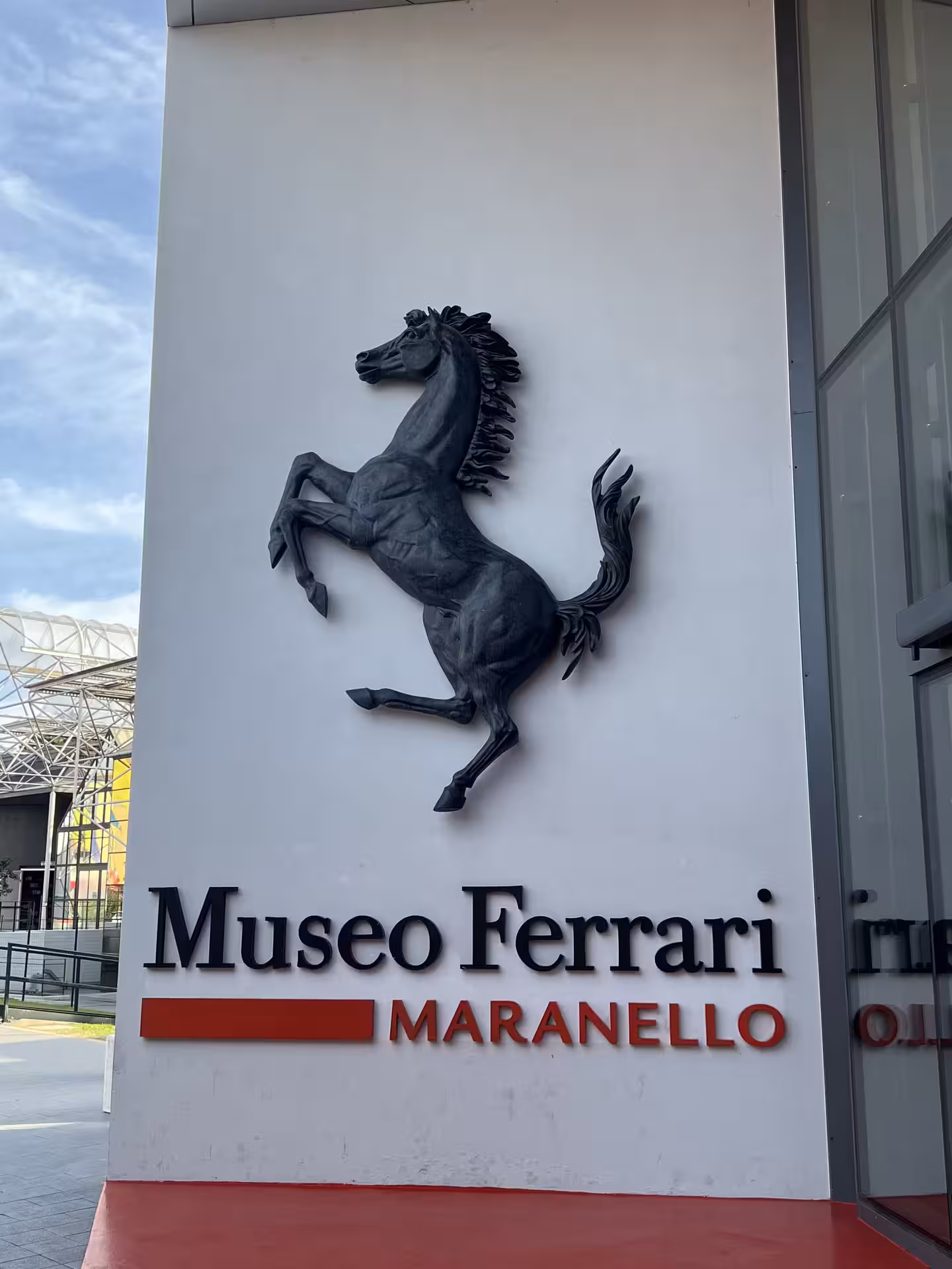 Entrance to Museo Ferrari Maranello, showcasing iconic prancing horse logo, a highlight of Bologna day trip tours.
