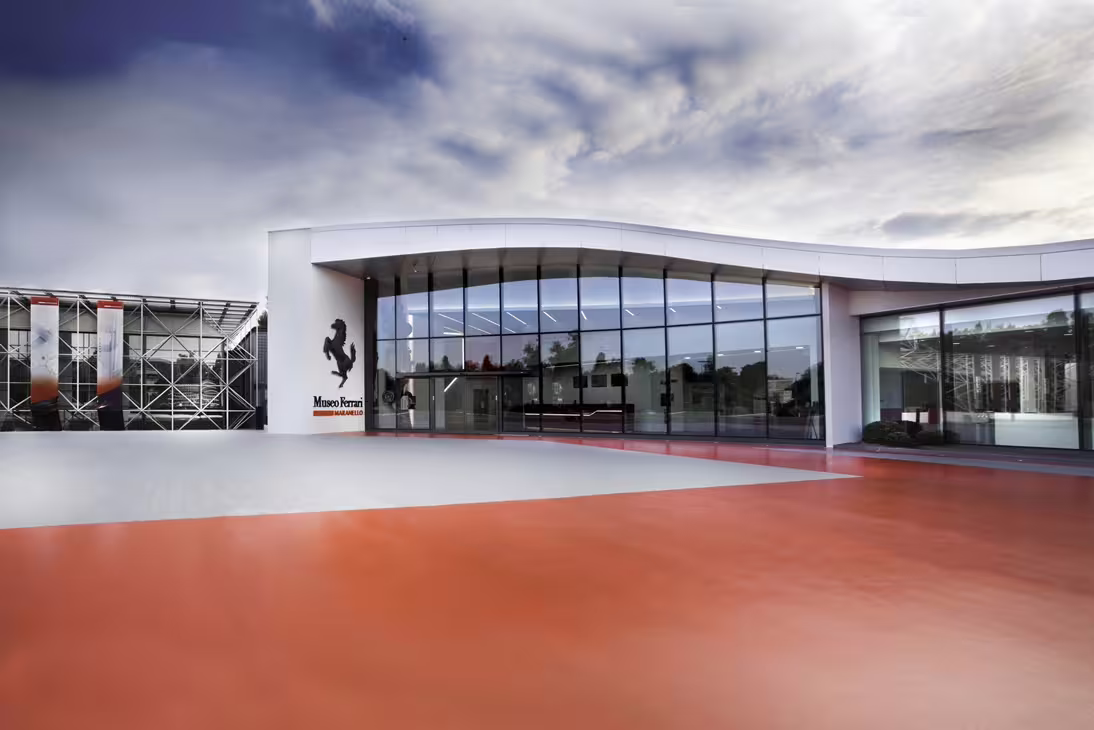 Exterior of Museo Ferrari Maranello entrance with glass facade, official Ferrari Museum entrance ticket access