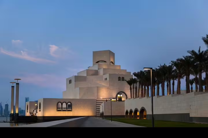 Elegant, modern architecture of the Museum of Islamic Art in Doha at dusk, showcasing its distinctive geometric design.