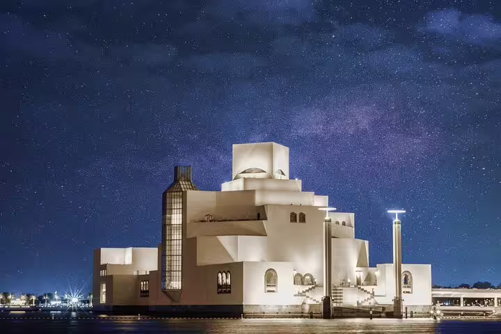 Museum of Islamic Art illuminated under a starry night sky, a must-see on the Doha Transit City Tour from Hamad Airport.