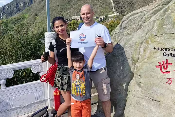 Family enjoying Mutianyu Great Wall tour with guide, showcasing scenic views and cultural exploration.