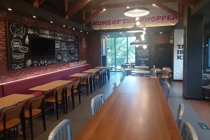 Interior of a cozy restaurant with wooden tables and chairs, ideal for relaxing during the Mutianyu Great Wall tour.