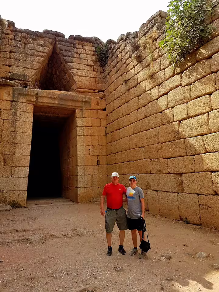 Visitors at Mycenae Lion Gate entrance on private Athens tour including Corinth Canal and Ancient Corinth