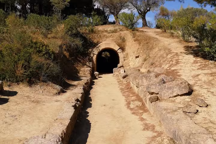 Entrance path to Mycenaean beehive tomb near Nafplio, featured on Epidaurus and Corinth Canal luxury tour