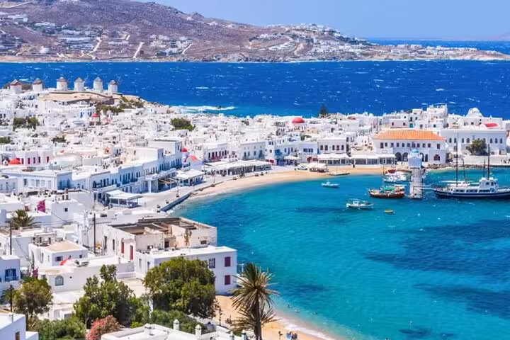 Panoramic view of Mykonos Town and old harbor with turquoise bay, ideal for a small group Chora walking tour