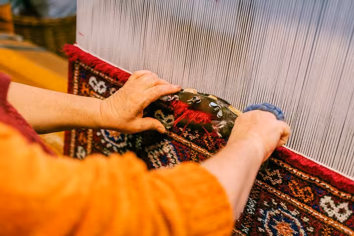 Hands weaving a traditional loom textile, immersive Mykonos 5-senses cultural craft experience tour