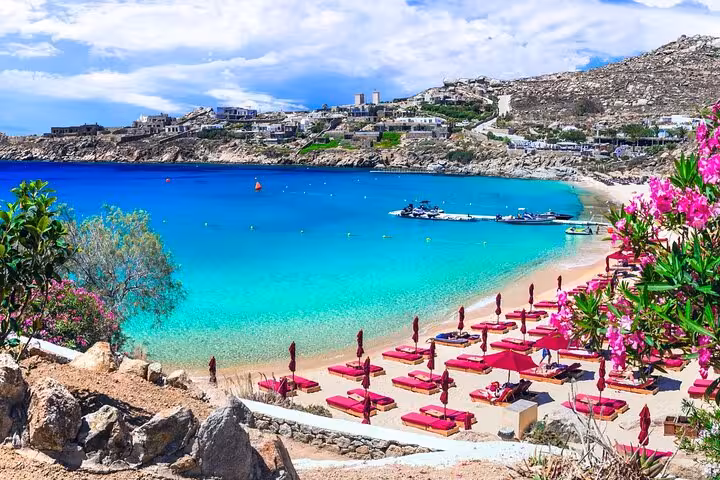Turquoise Mykonos beach with sunbeds and bay views, ideal stop on a Mykonos island shore excursion tour