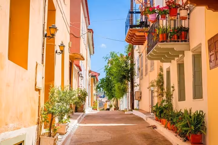 Charming Nafplio old town alley with colorful houses and flowered balconies on a private day trip from Athens