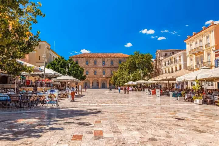 Nafplio old town main square with shaded cafes and neoclassical buildings on a private day tour from Athens