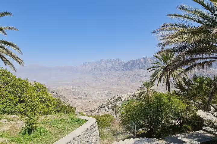 Panoramic view of lush greenery and distant mountains from Wakan Village on the Nakhal Hotspring tour.