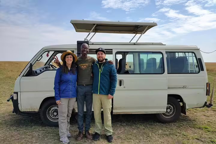 Travelers posing with guide beside a safari van in Nakuru, capturing the essence of private wildlife tours in Kenya.