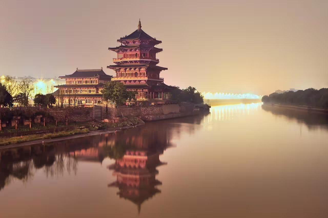 Scenic view of illuminated traditional pagoda reflecting on the river during the Nanjing Cultural Experience tour.