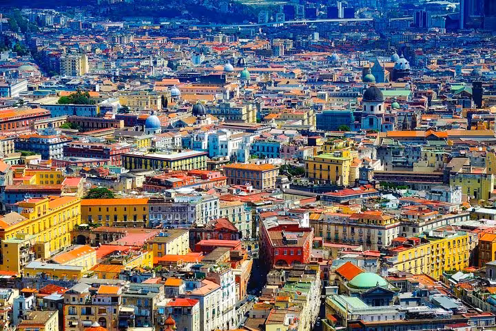 Vibrant aerial view of Naples cityscape, perfect for private transfer to Sorrento via hotel, airport, or train station.