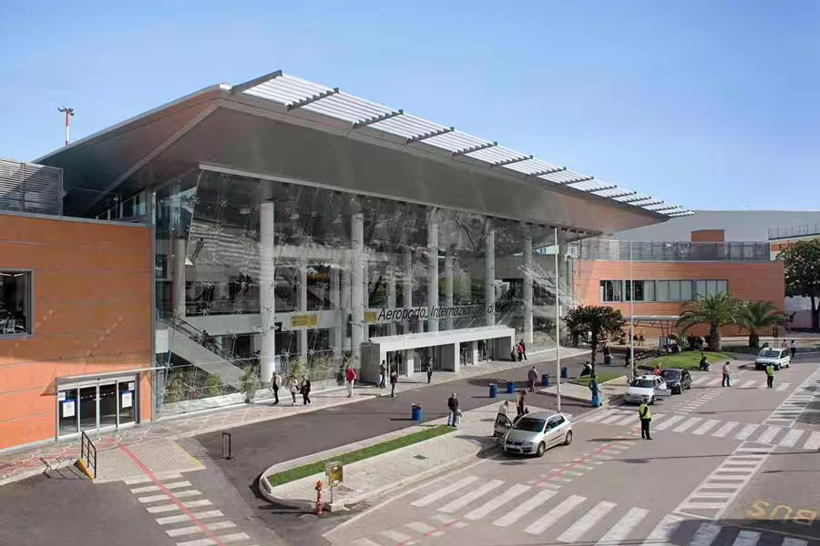 Naples International Airport terminal pickup point for private transfer to Salerno, reliable chauffeur and luggage help