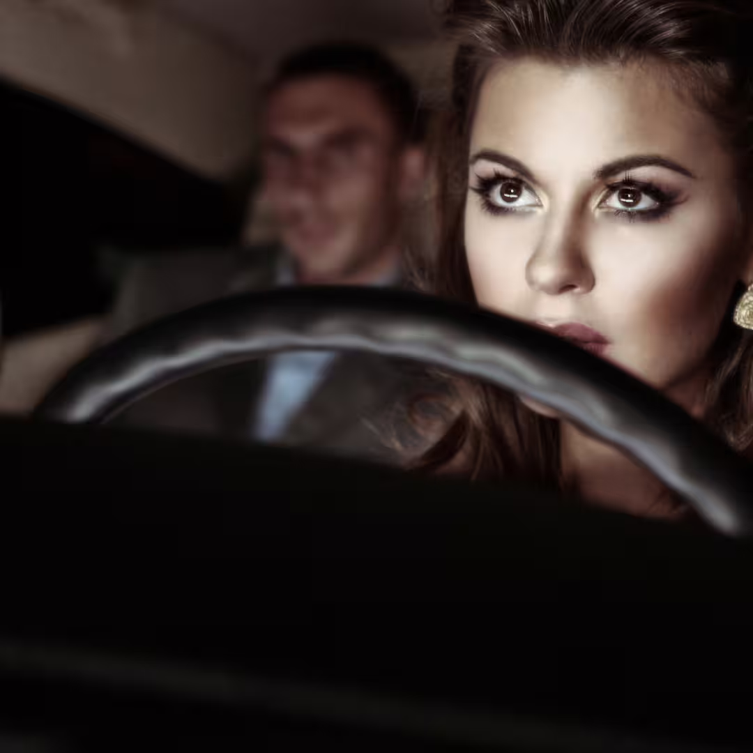 Elegant chauffeur driving business traveler on a comfortable Naples to Amalfi Coast private transfer service