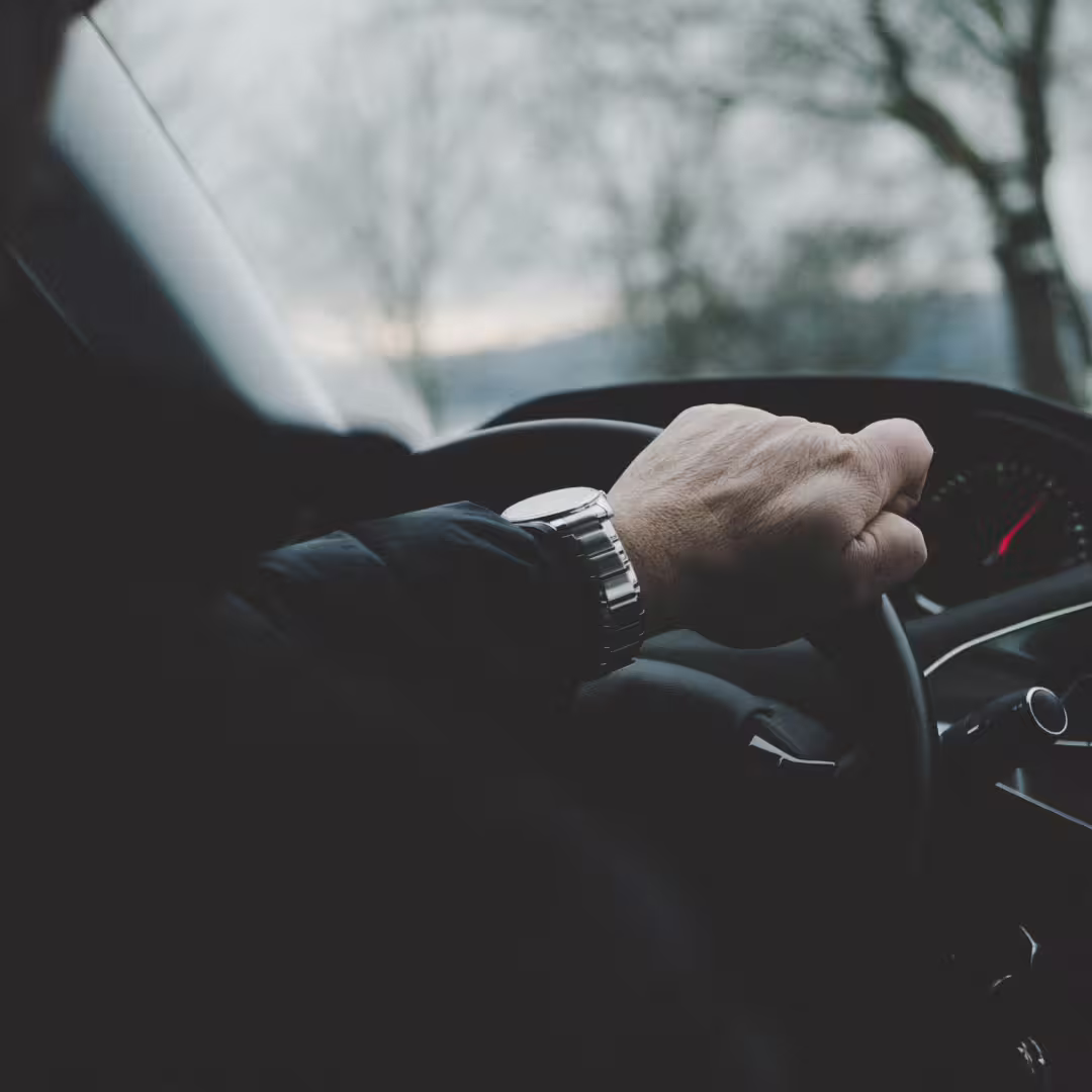 Private driver on highway steering wheel close-up during Naples to Avellino transfer in modern air-conditioned car