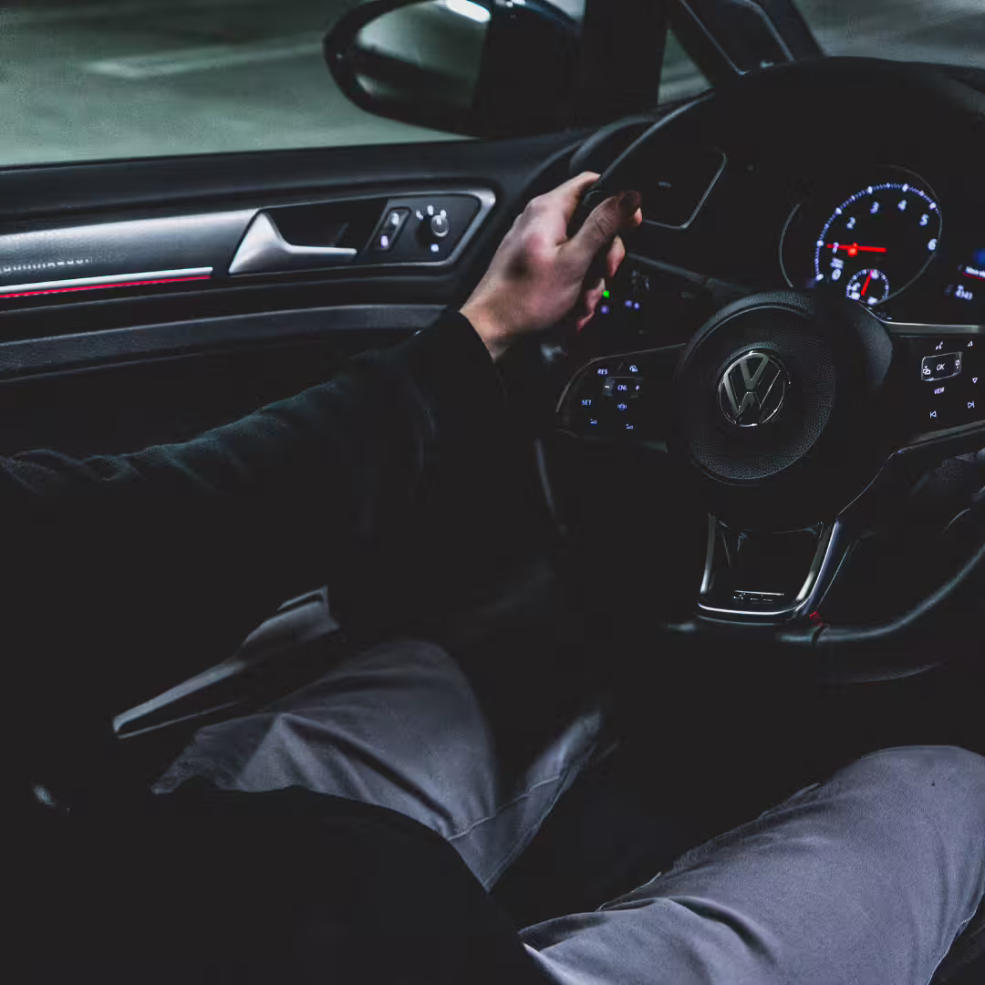 Professional driver at night steering premium vehicle during safe, reliable Naples to Avellino private transfer