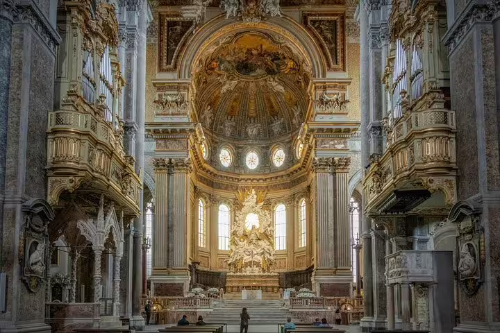 Opulent baroque interior of a Naples church with golden altar and frescoed dome on the saints and secrets walking tour