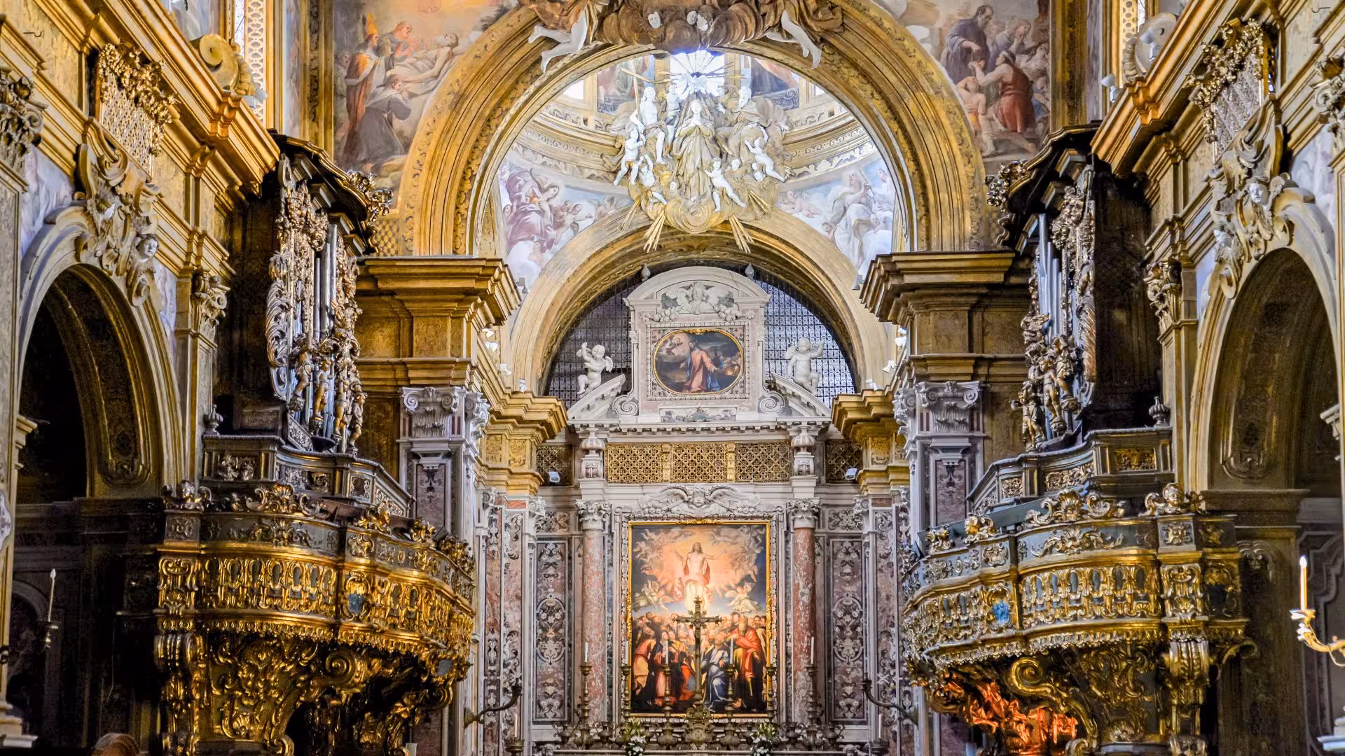 Discover the opulence of Naples' baroque church interior featuring intricate gold detailing and vivid frescoes.
