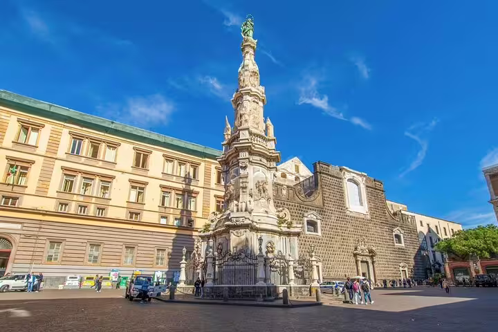Baroque obelisk and historic church in Piazza del Gesù Nuovo on a legends and saints walking tour of old Naples, Italy