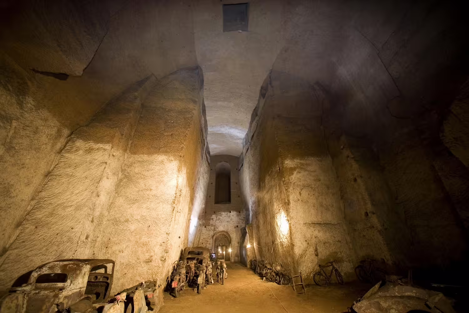 Vast vaulted chamber of Naples’ Bourbon Tunnel with rusted cars and bikes reveals the city’s hidden underground world