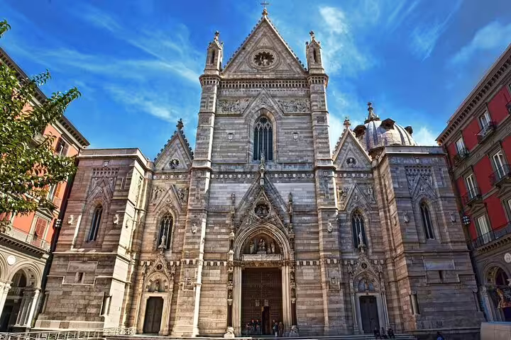 Gothic facade of Naples Cathedral under blue sky, a key stop on the Legends of Naples superstitions and saints tour