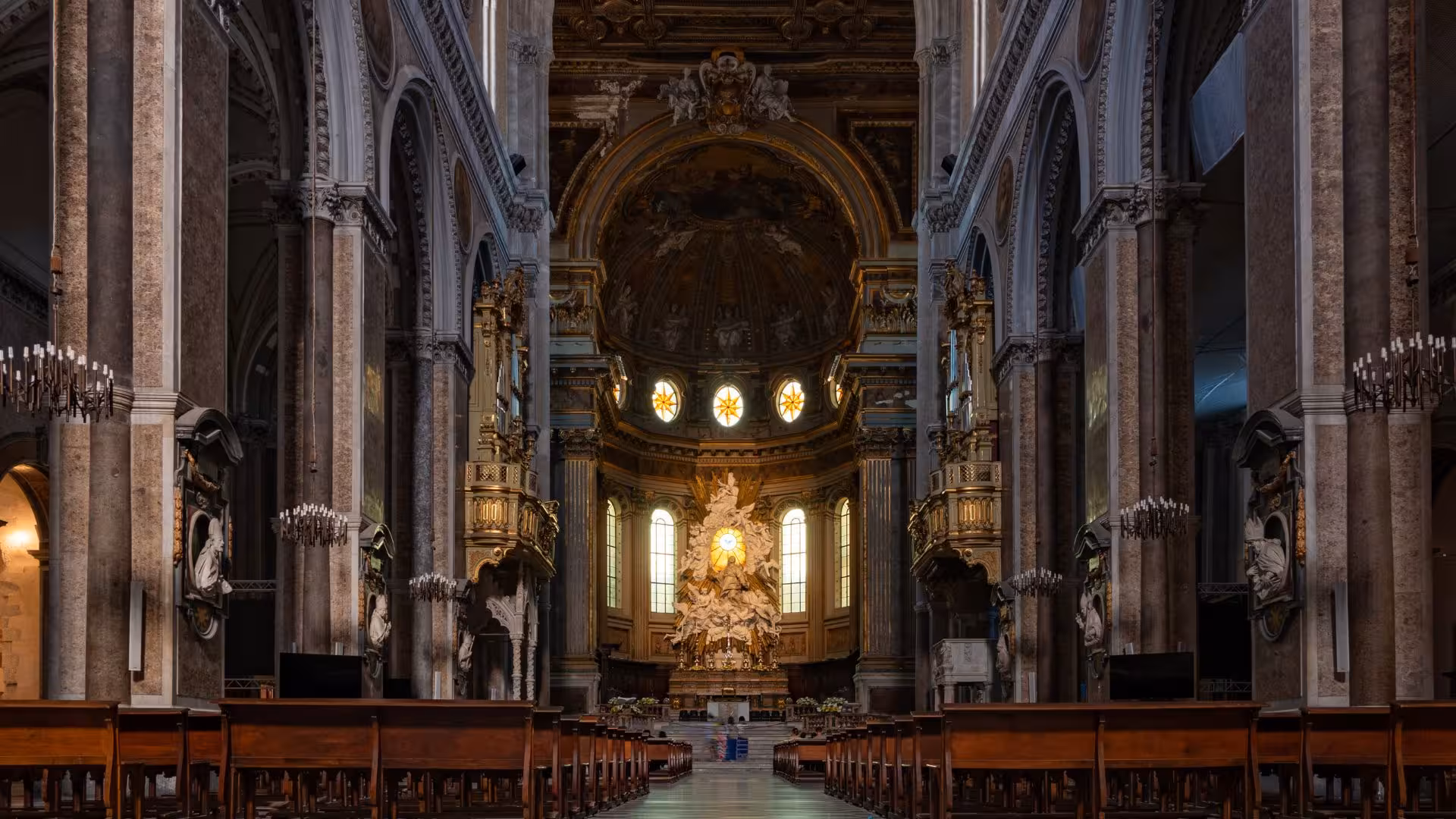 Explore the grand interior of a historic Naples cathedral with ornate columns and intricate architectural details.