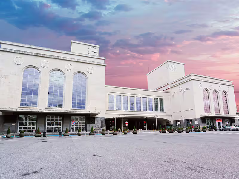 Naples Centrale railway station facade at sunset, meeting point for private transfer Naples to Salerno or vice versa