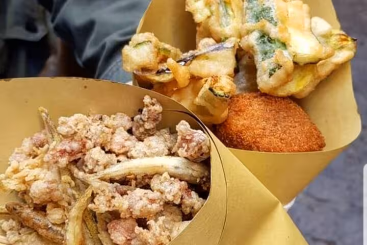 Golden fried Italian street food assortment in paper cones, showcasing Naples' authentic culinary flavors.