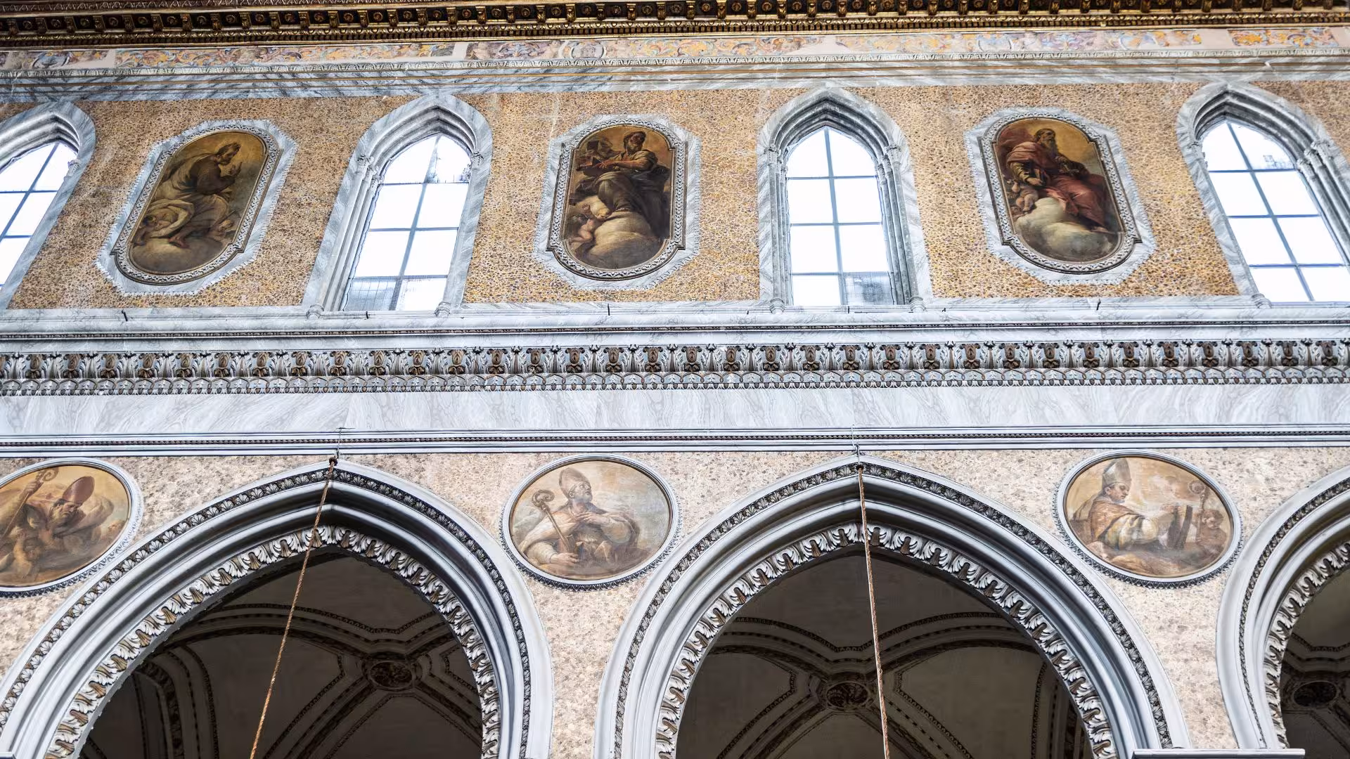 Admire detailed frescoes and arches in Naples' historic sites, reflecting Greek-Roman artistic heritage.
