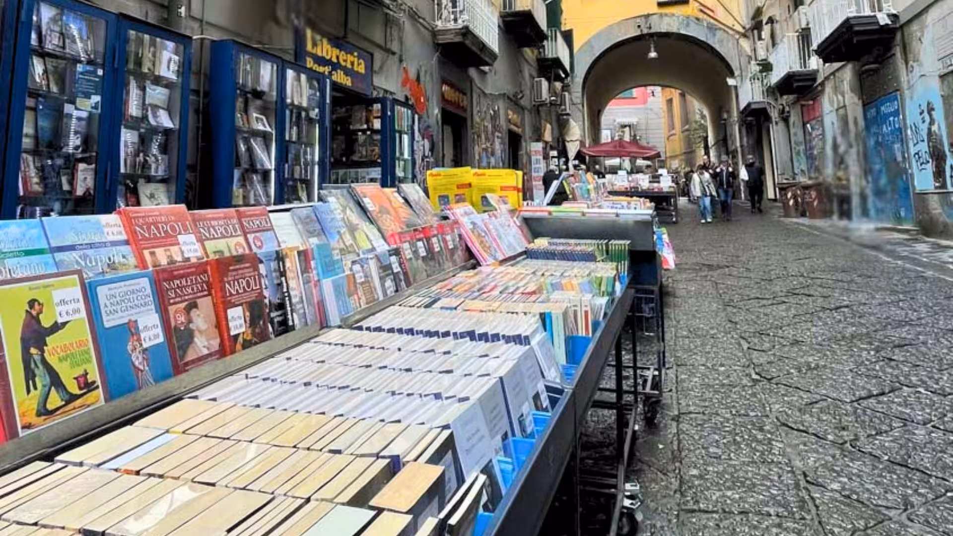 Colorful book market in Naples' historic center, offering a vibrant display of local literature and culture.