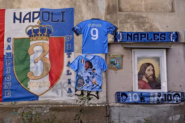 Naples street shrine with Napoli 2022/23 banner and Maradona mural, ideal stop on legacy tour and pizza walk