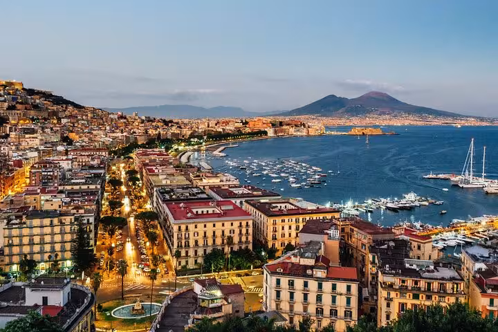 Experience a breathtaking sunset view over Naples and Mount Vesuvius, perfect for a memorable private tour and winery visit.