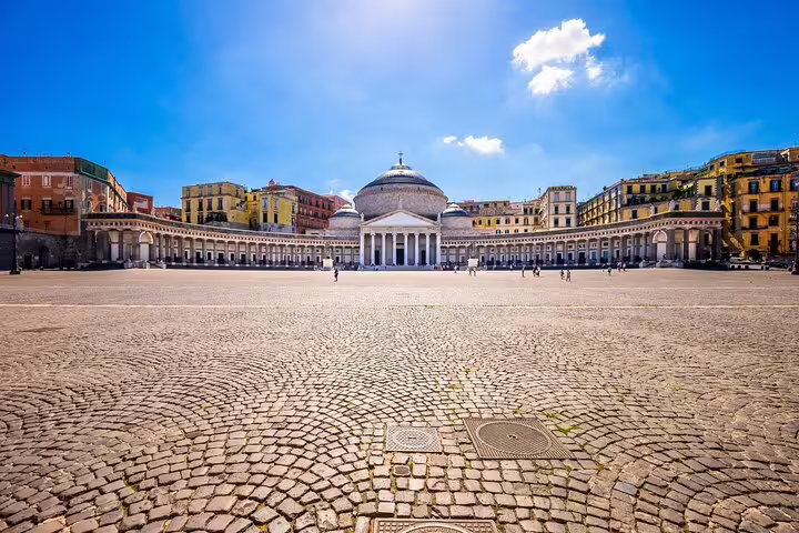 Vibrant view of Piazza del Plebiscito in Naples, showcasing historic architecture under a clear blue sky during a private tour.