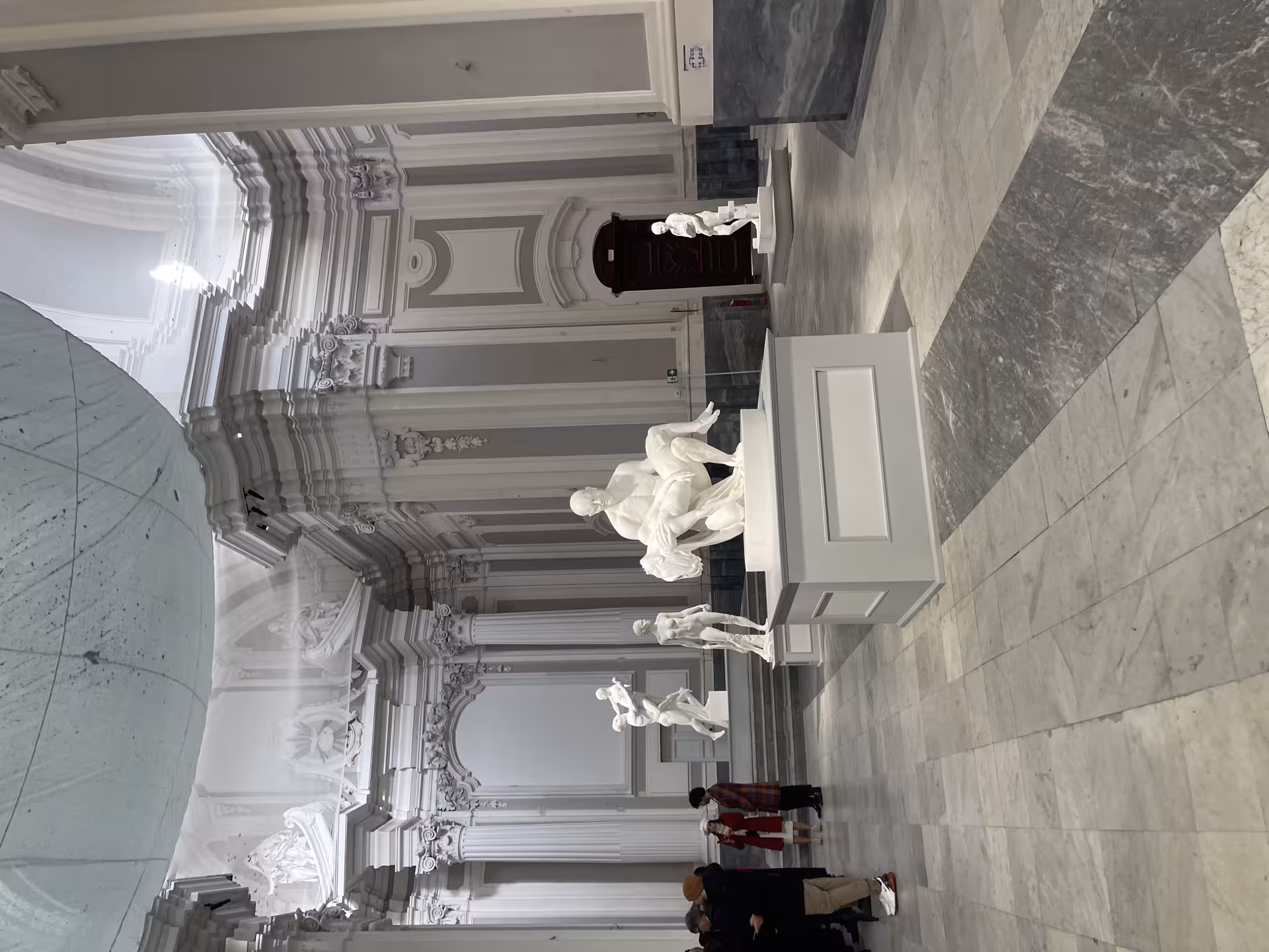 Elegant museum interior with classical white statues in Naples' Sanità district tour.