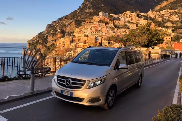 Luxury private transfer van with scenic view of Sorrento coast, ideal for Naples to Sorrento transport.