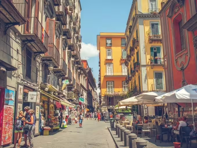 Bustling Naples old town street with cafes and shops, perfect backdrop for a Naples street food walking tour