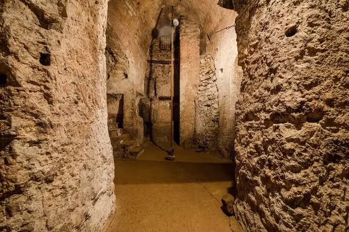 Mysterious underground passage in Naples featuring ancient stone walls, a highlight of the city's historical ruins tour.